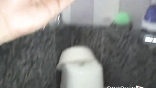 Solo performer with a toy on rumpled bedsheets