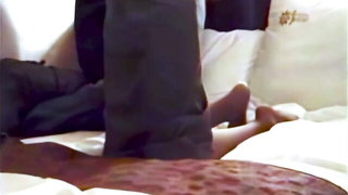 Couple mid-scene in a dim bedroom