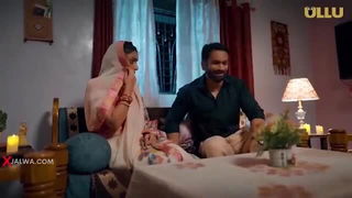 Couple on a made bed in an explicit scene