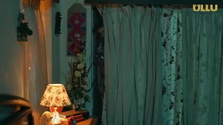 Couple on a patterned bedspread in an explicit scene