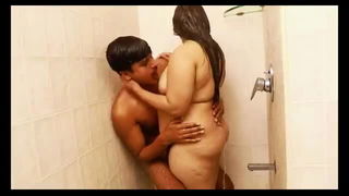 Couple mid-scene in a dim bedroom