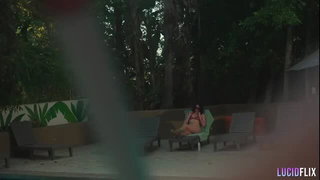 Couple mid-scene in a dim bedroom