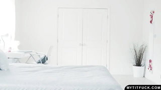 Solo performer with a toy on rumpled bedsheets