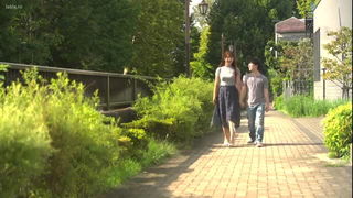 Couple mid-scene in a dim bedroom