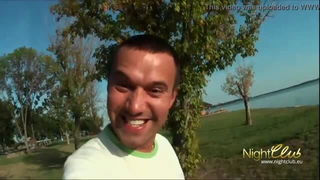 Solo performer with a toy on rumpled bedsheets