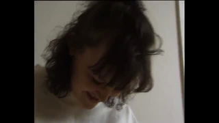 Explicit massage scene in a softly lit room
