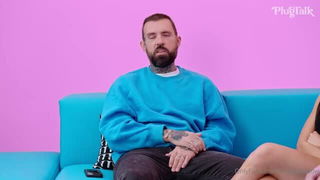Couple on a made bed in an explicit scene