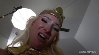 Solo performer with a toy on rumpled bedsheets
