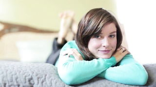 Explicit massage scene in a softly lit room