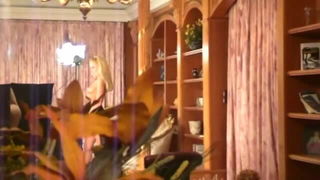 Couple on a made bed in an explicit scene