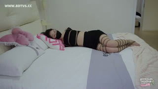 Couple on a made bed in an explicit scene