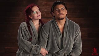 Couple mid-scene in a dim bedroom