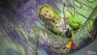 Studio set with performers in an explicit scene under bright lights
