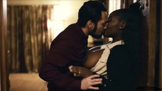 Couple on a patterned bedspread in an explicit scene