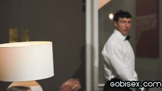 Couple on a made bed in an explicit scene