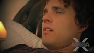 Explicit massage scene in a softly lit room