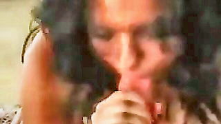 Explicit massage scene in a softly lit room