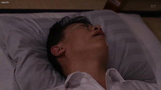 Couple on a made bed in an explicit scene
