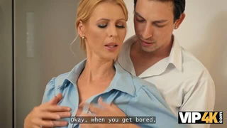 Couple on a patterned bedspread in an explicit scene
